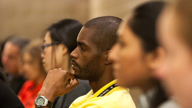 A male student listens to a lecture.