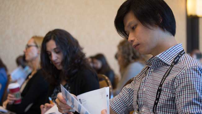 A male student looks over his notes. 