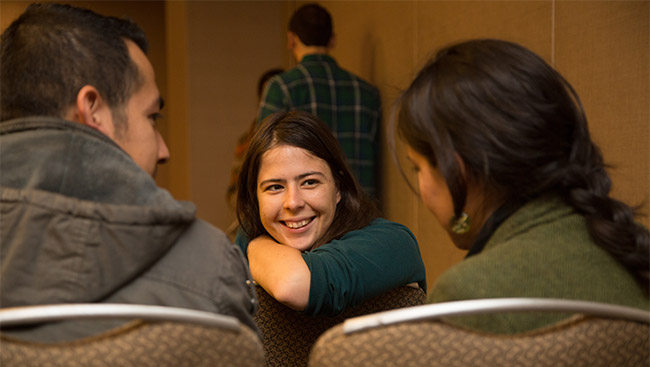 A male and two female scientists have a discussion. 