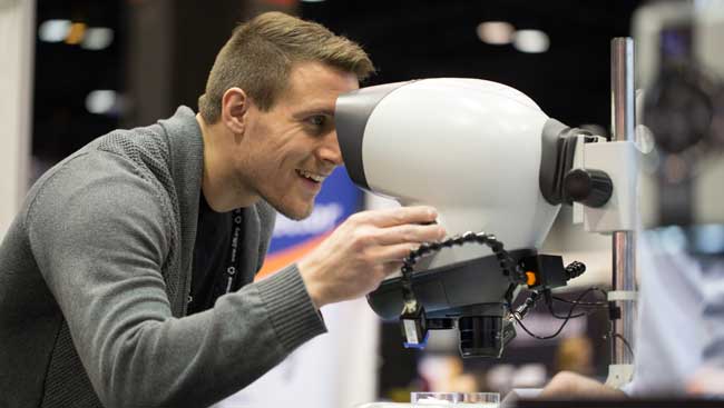 A male neuroscientist uses new lab equipment. 