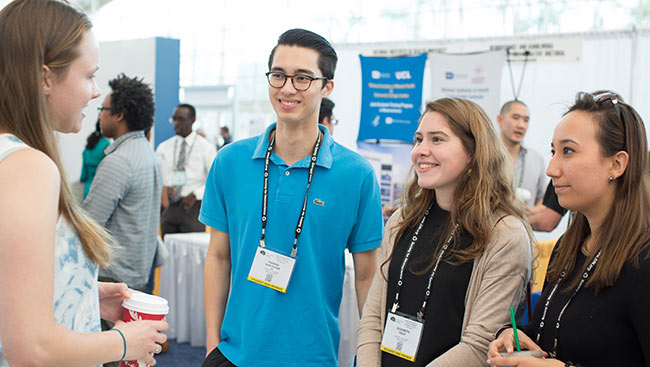 Undergraduate students attend a conference. 