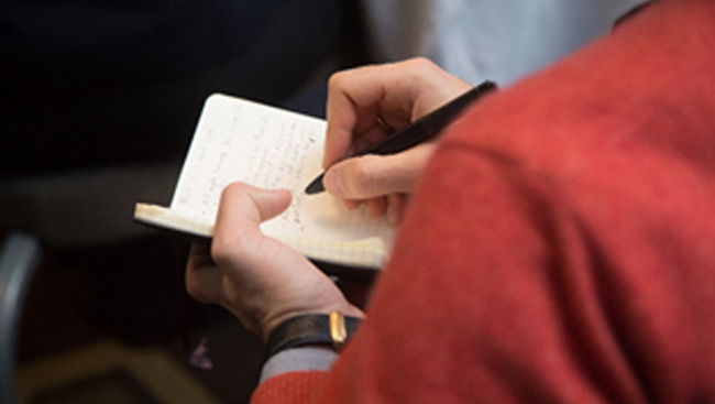 Person writing in a notebook