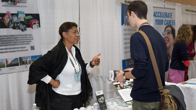 Attendee visiting grad school booths at Neuroscience 2017