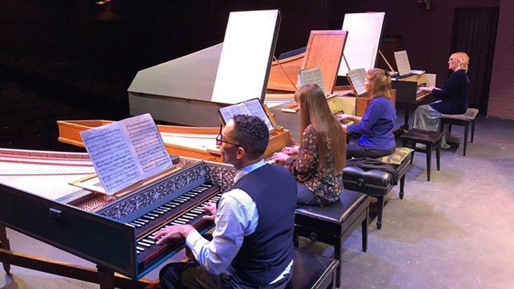 Patricia Izbicki, author of the article, plays piano with three other musicians.