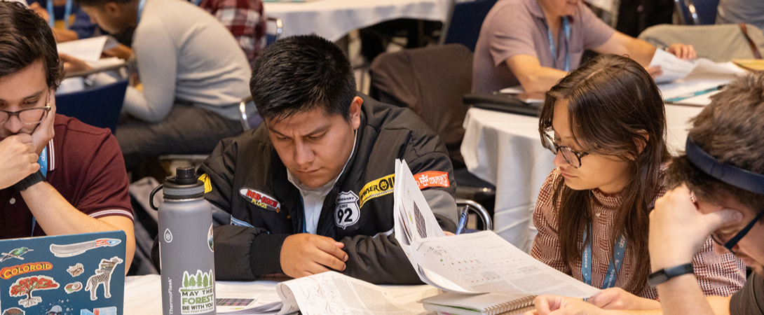 Members sitting around a table reading