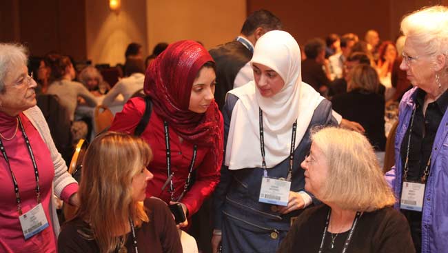 Female neuroscientists talking at SfN's annual meeting.