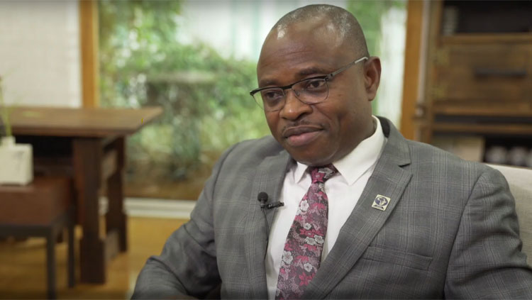 Amadi Ihunwo sitting in an office during an interview.