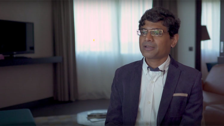 Srikanth Ramaswamy sitting in front of a window during an interview.
