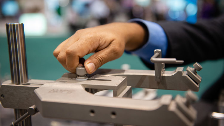 An image of a hand adjusting the base of an instrument