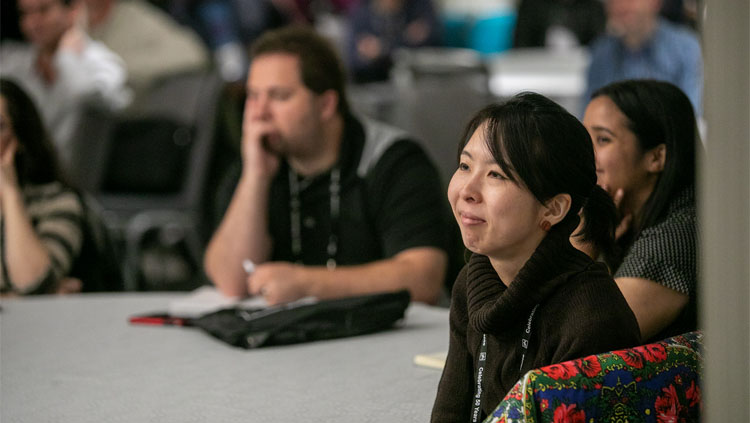 Three people sitting at a round table listening to the Meet the Experts lecture at Neuroscience 2019