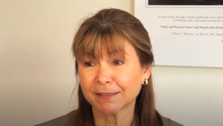 A woman speaks to the camera.