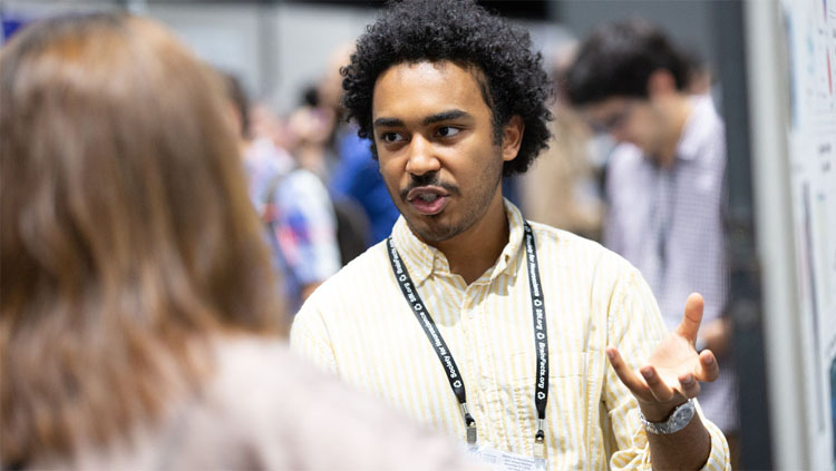 A man explains his science to an onlooker.