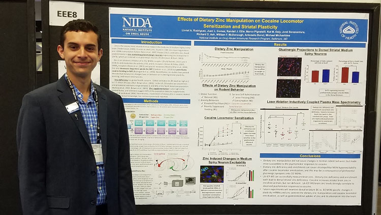 Lionel Rodriguez poses with his poster at the Society for Neuroscience annual meeting.