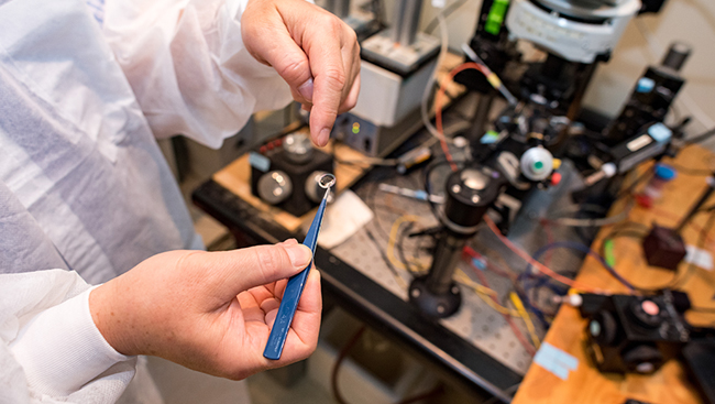 Photo of scientist handling an instrument