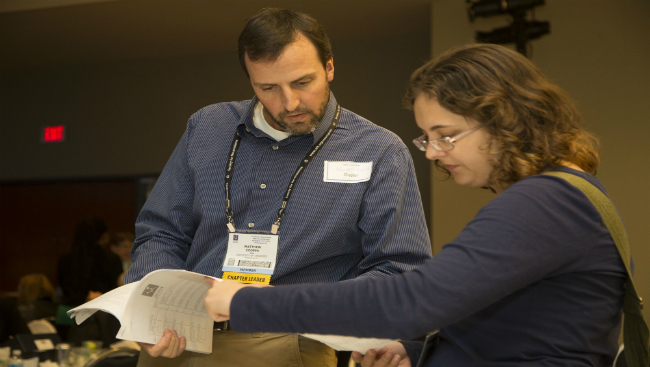An image of a man and a woman looking at papers