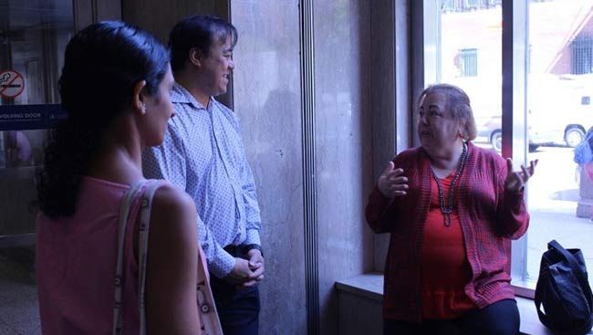 A male scientist meets with a state senator to discuss funding opportunities. 