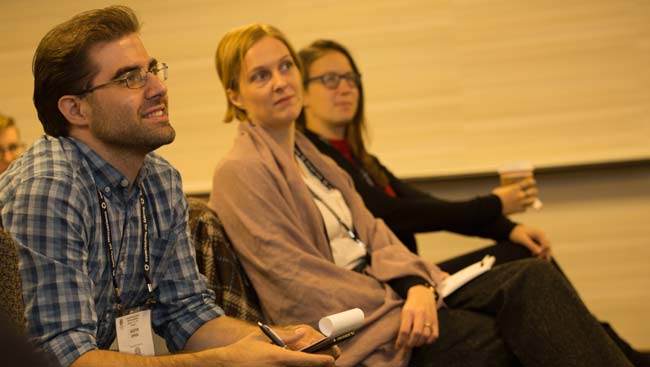 A male neuroscientist listens to a lecture. 