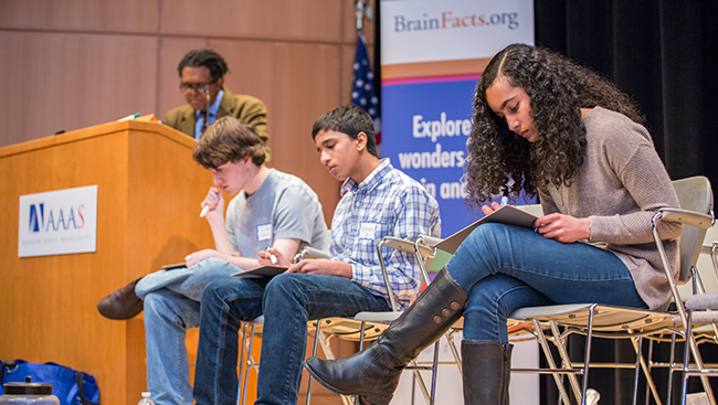 Three students participate in a presentation