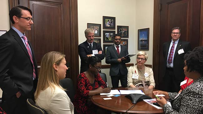 Male and female neuroscientists meet with representatives. 