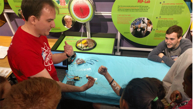 Andrew Bankston does neuroscience outreach by teaching students about neuroscience.