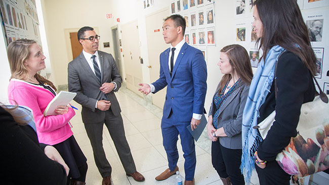 A group of people standing in a semicircle having a conversation during SfN's Capitol Hill Day 2017