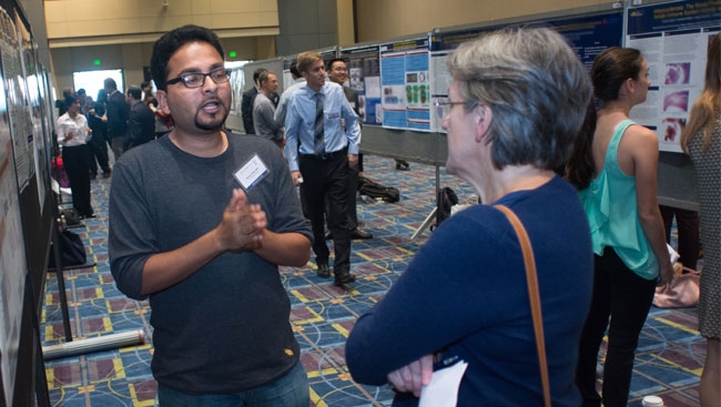 Drexel University student presents a scientific poster.