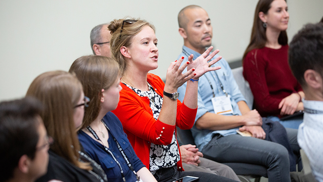 Meeting attendee speaking in a breakout group at Neuroscience 2018