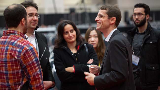 A group of diverse neuroscientists laughing and talking.