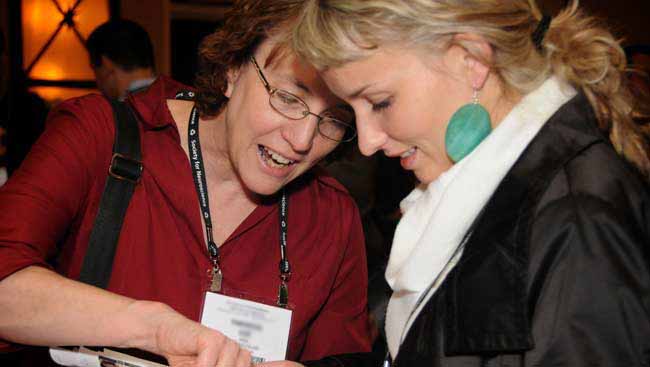 Two females discuss scientific work. 