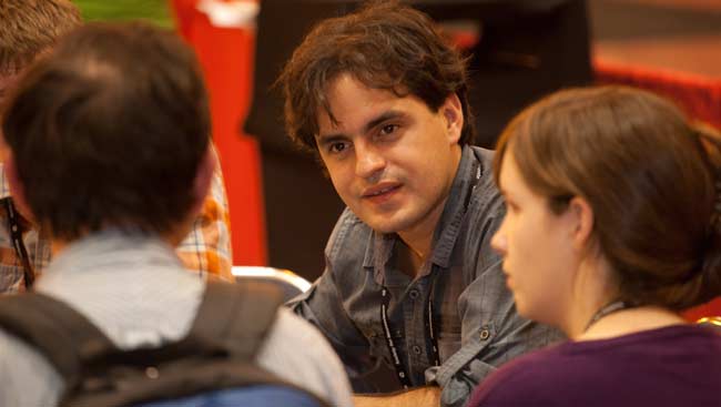 Young male and female neuroscientists converse.