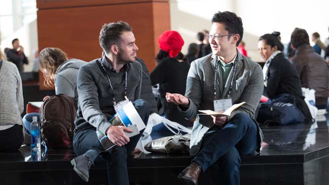 Two male neuroscientists network at a conference. 