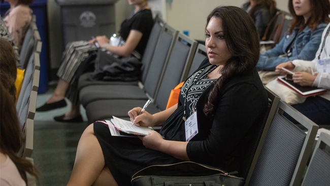 Attendee taking notes at the Professional Development Workshop, "How a Journal Handles Your Paper"