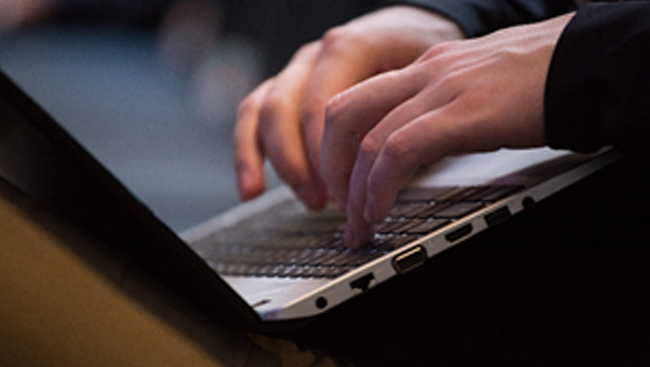 Person typing on a laptop computer