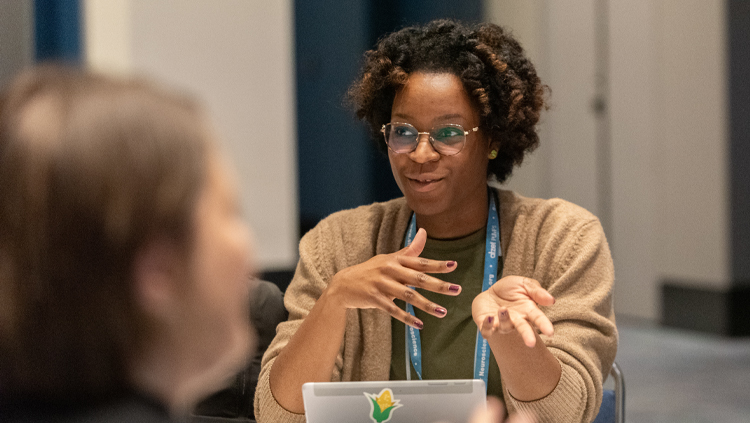 woman speaking at a table discussion at Neuroscience 2025
