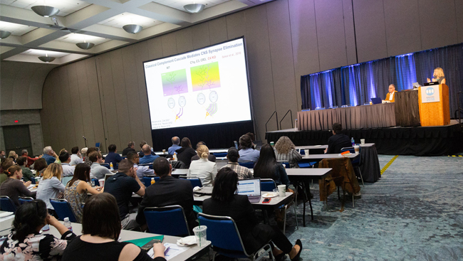 A crowd listens to The Role of Innate Immunity in Neurological Disorders lecture.