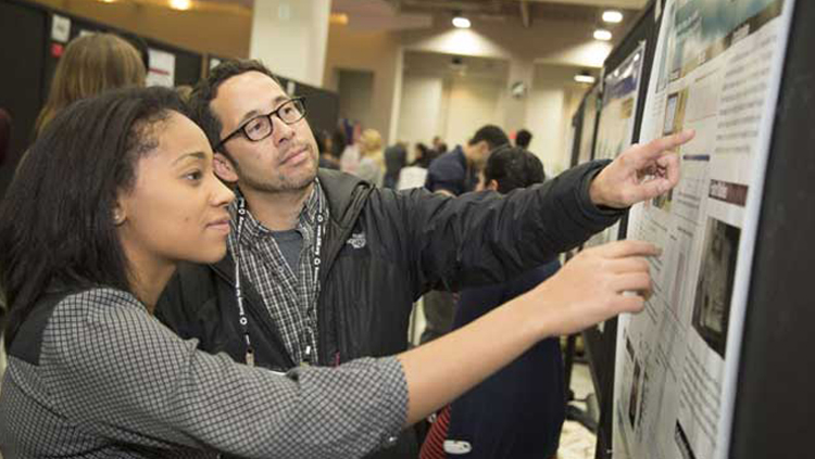 Young scientists look at poster presentation