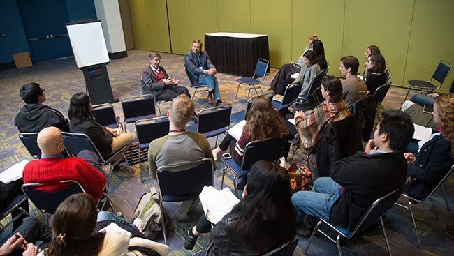 A group of students listens to a lecture. 