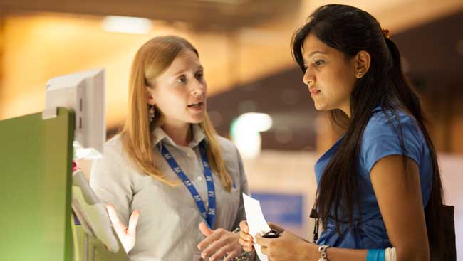 A female neuroscientist learns about new technology at a conference. 
