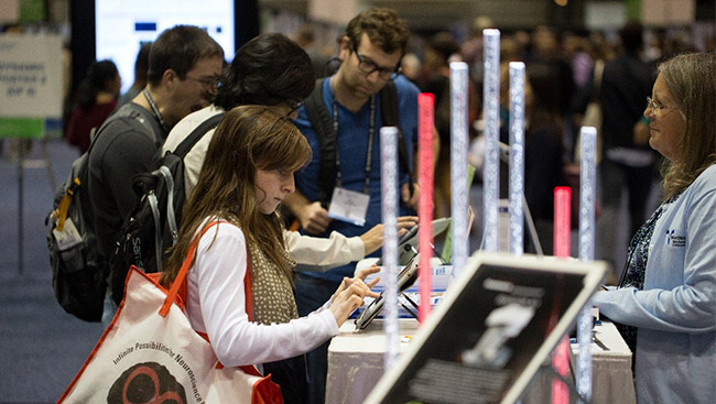 A female neuroscientist learns about a new technology. 