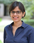 Headshot of Aparna Shah standing outside wearing a navy blue button up shirt.