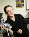 Image of Cyntha Chestek in a lab holding a robotic hand 