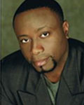 Headshot of David Hodge wearing a black button down shirt.