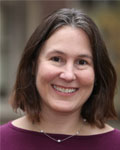 Headshot of Frances Champagne wearing a plum colored shirt and silver necklace