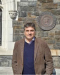 Gonzalo Torres standing in front of a stone wall.