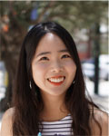 Headshot of Hyejung Won wearing red lipstick and a striped tank top.