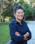 Image of Lena Ting standing in front of trees with her arms crossed