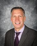 Headshot of Nicholas Zingale wearing a purple tie with a gray jacket.