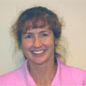Headshot of Melissa Harrington wearing a pink collared shirt.