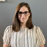 Headshot of Rachel Haake. She has shoulder length brown hair, brown glasses, and a white and gray striped shirt.